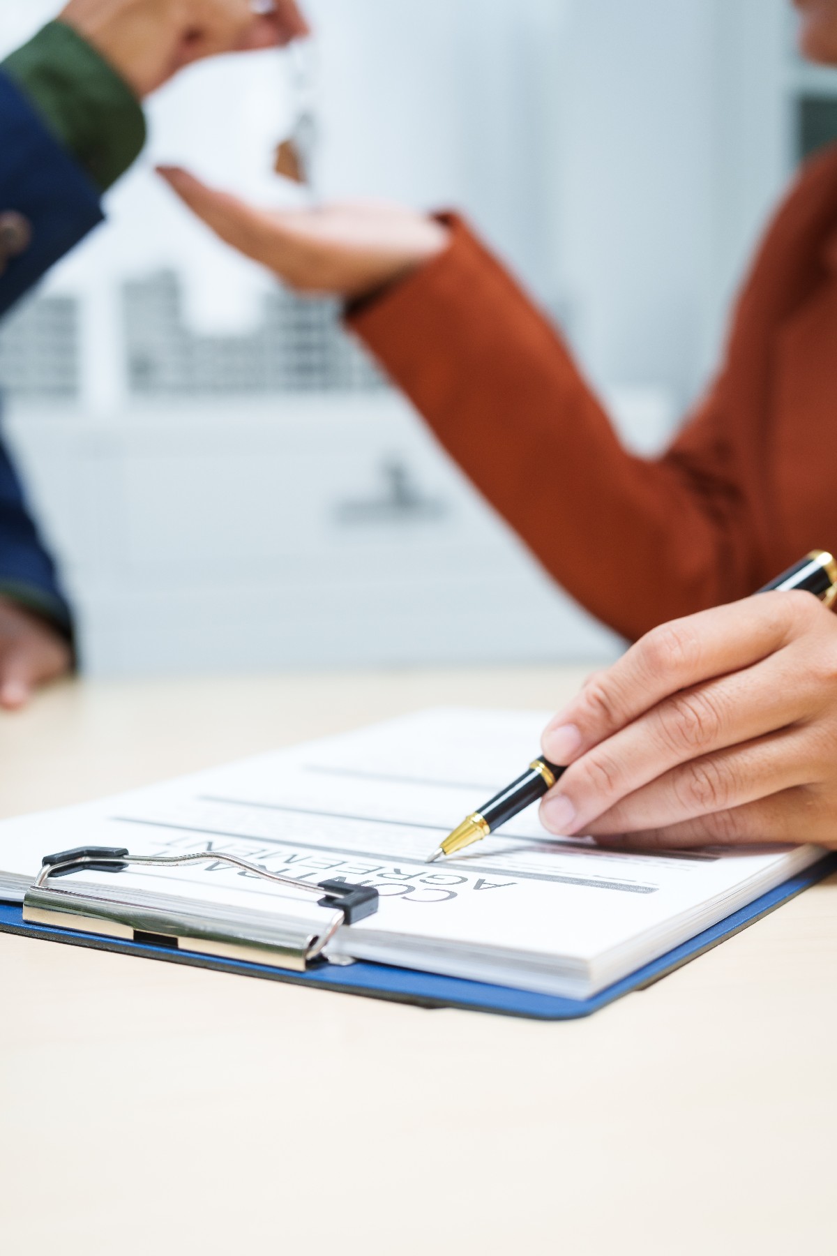 A Businessman At A Desk In A Sales Office Sells A Condo Buildin